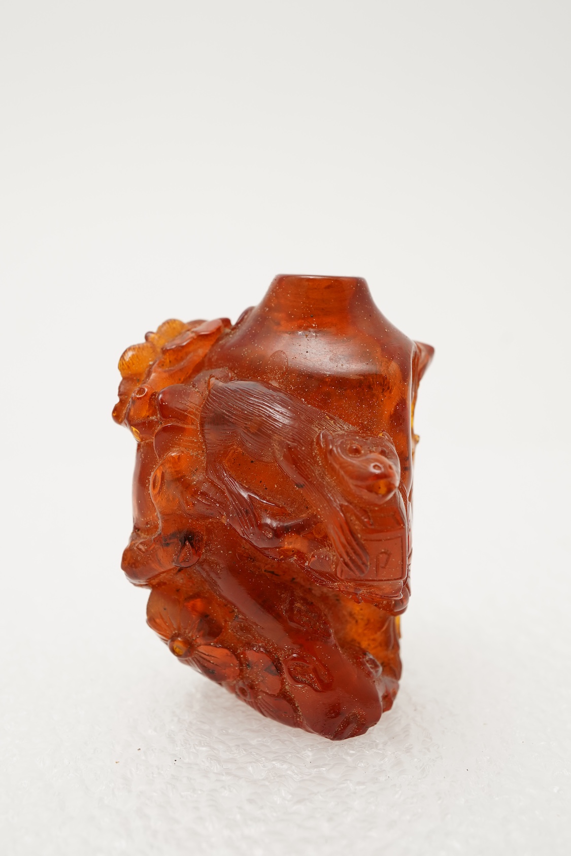 A Chinese caved amber snuff bottle, 19th century